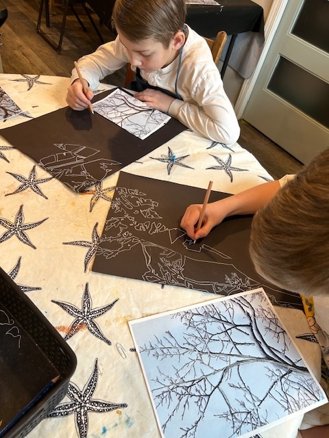 Young student holding a heart-themed art project