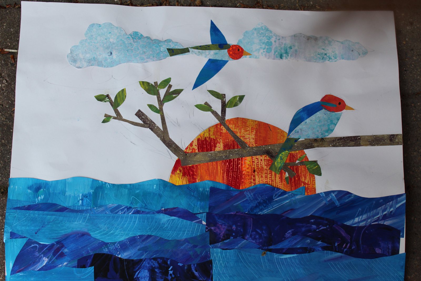 Instructor demonstrating an art project at a classroom table